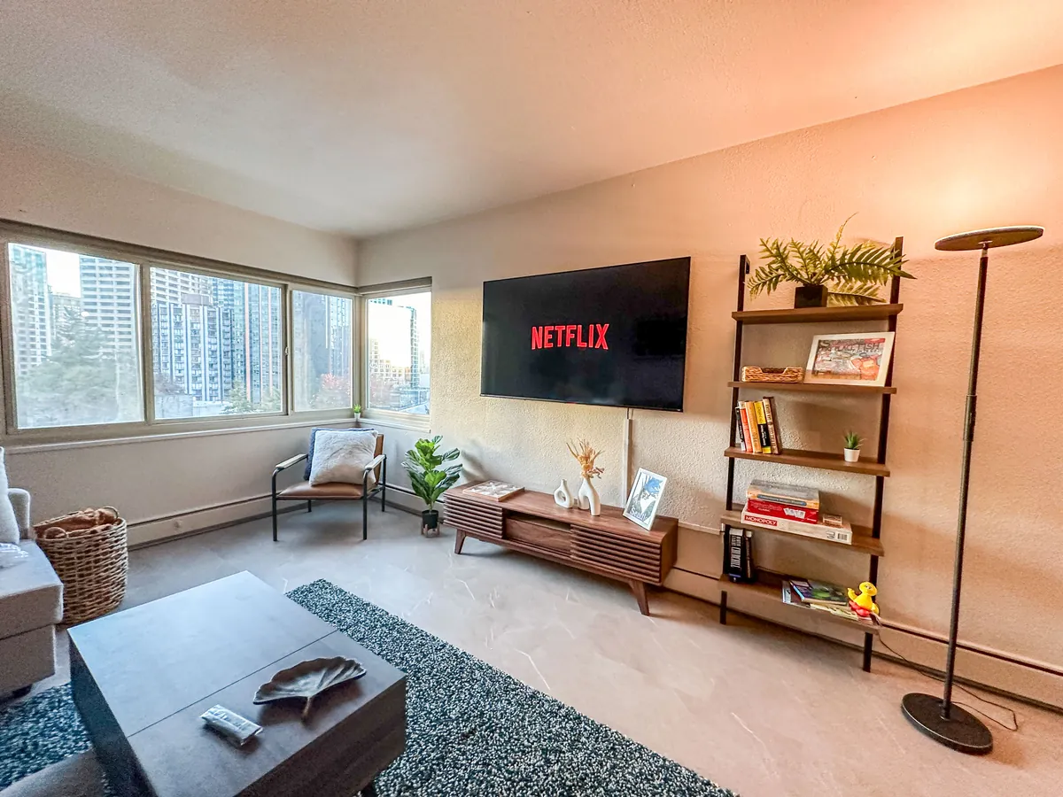 Open living room with windows, TV wall and shelving