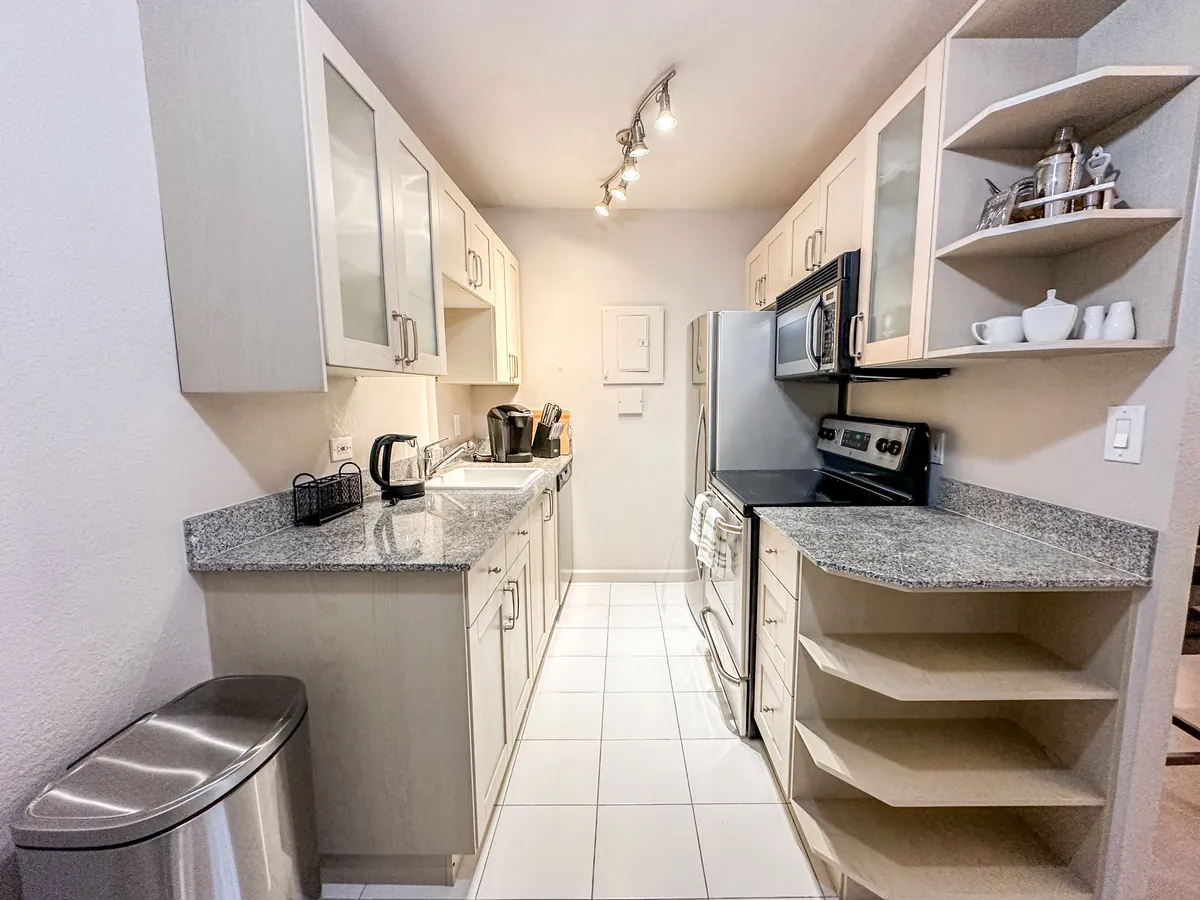 Kitchen with granite counters and glass-front cabinets