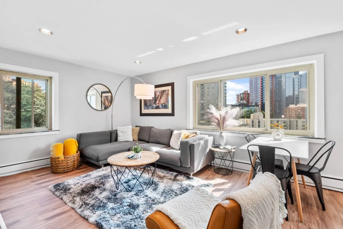 Top-floor living room with big windows and skyline light