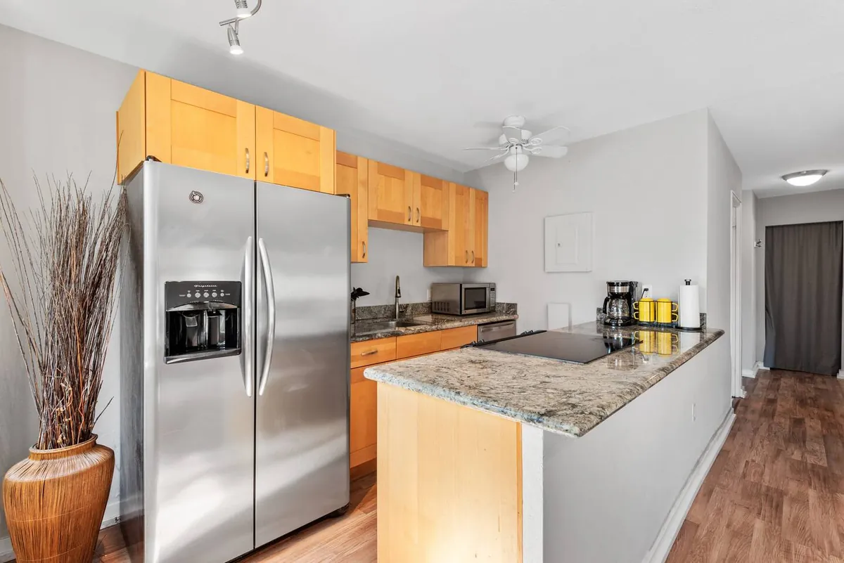 Kitchen with stainless steel appliances and breakfast bar